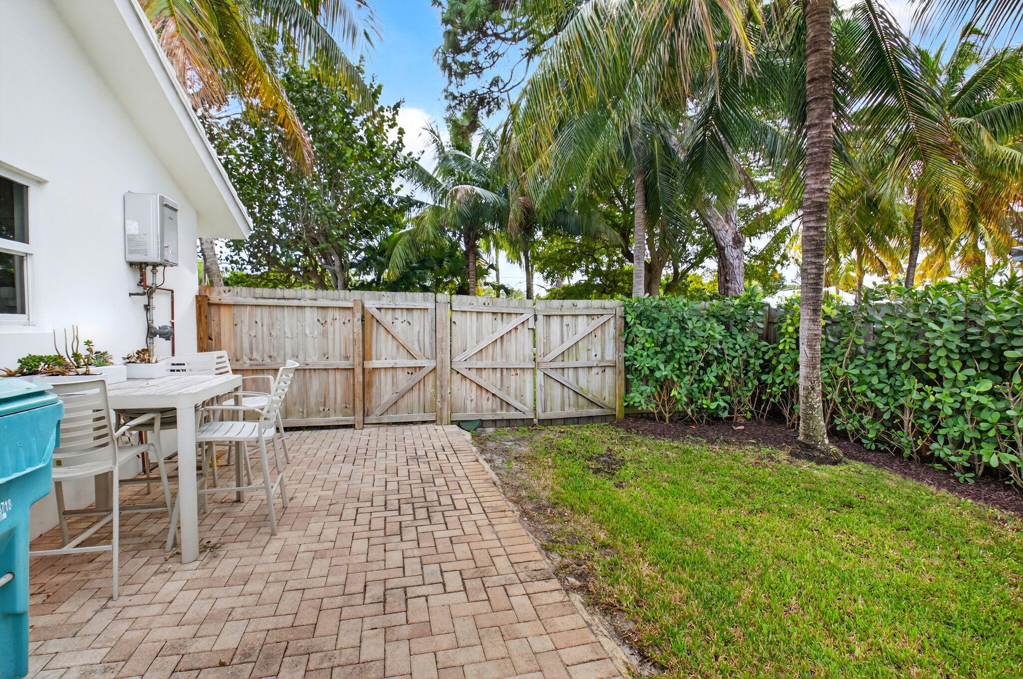 525 Sunset Road Boynton Beach, FL 33435 - Photo 53 of 62 a view of a patio with table and chairs and potted plants