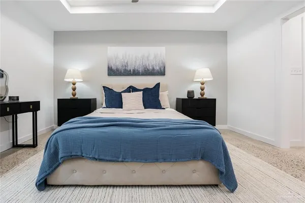 a living room with furniture a flat screen tv and a kitchen view