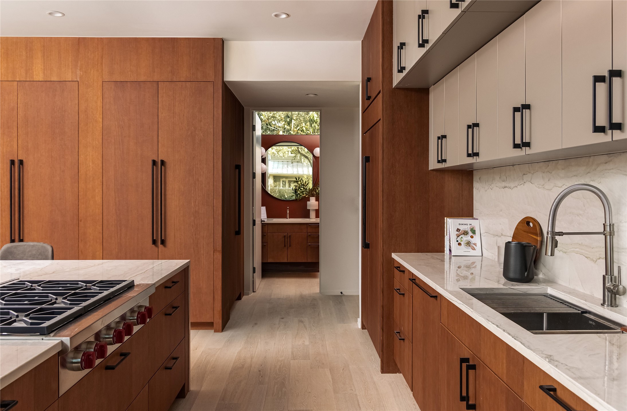 915 Columbus Street Austin, TX 78704 - Photo 15 of 34 Kitchen with brown cabinetry, stainless steel gas cooktop, light wood finished floors, modern cabinets, and recessed lighting