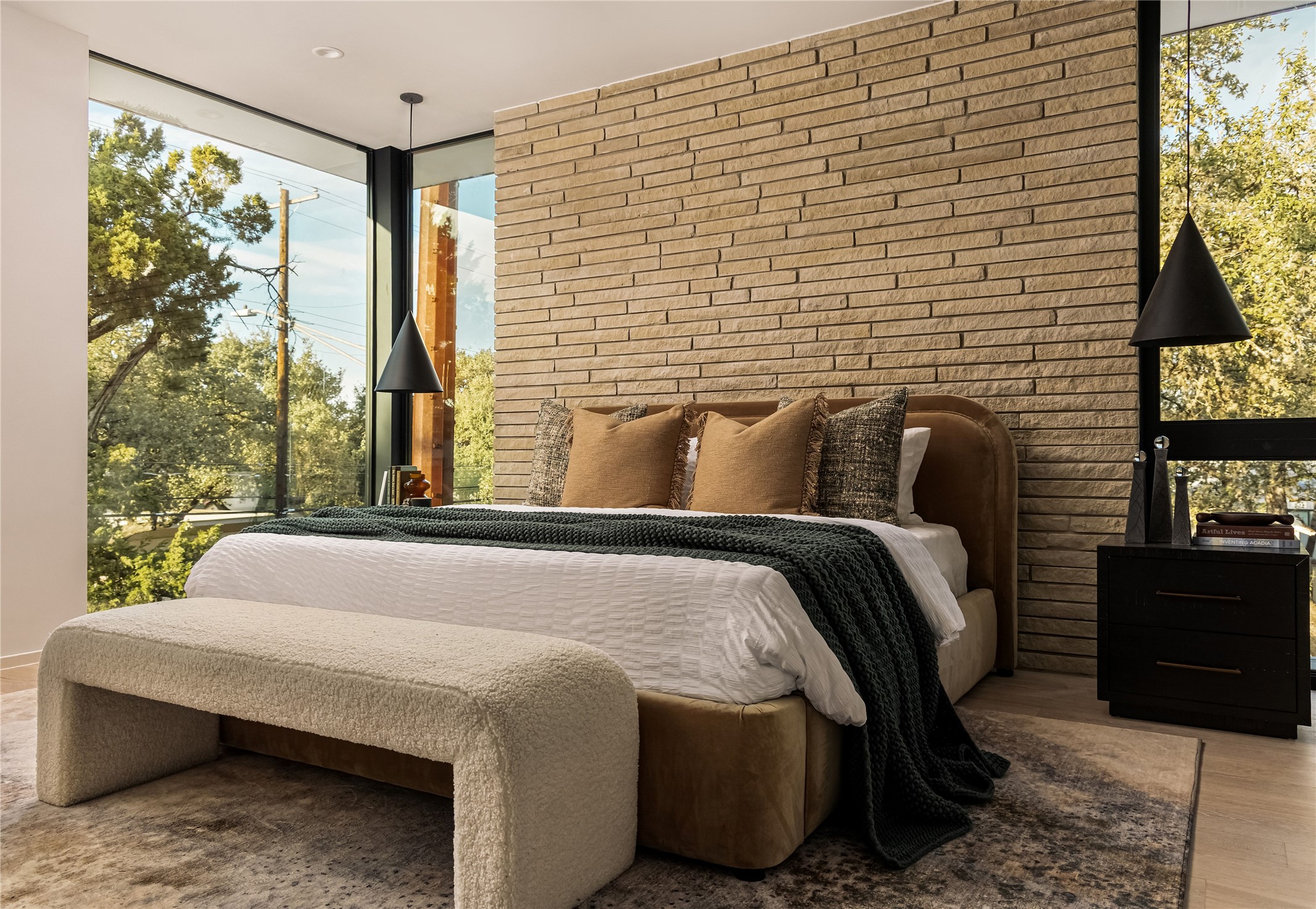 915 Columbus Street Austin, TX 78704 - Photo 18 of 34 Bedroom featuring floor to ceiling windows, brick wall, and wood finished floors