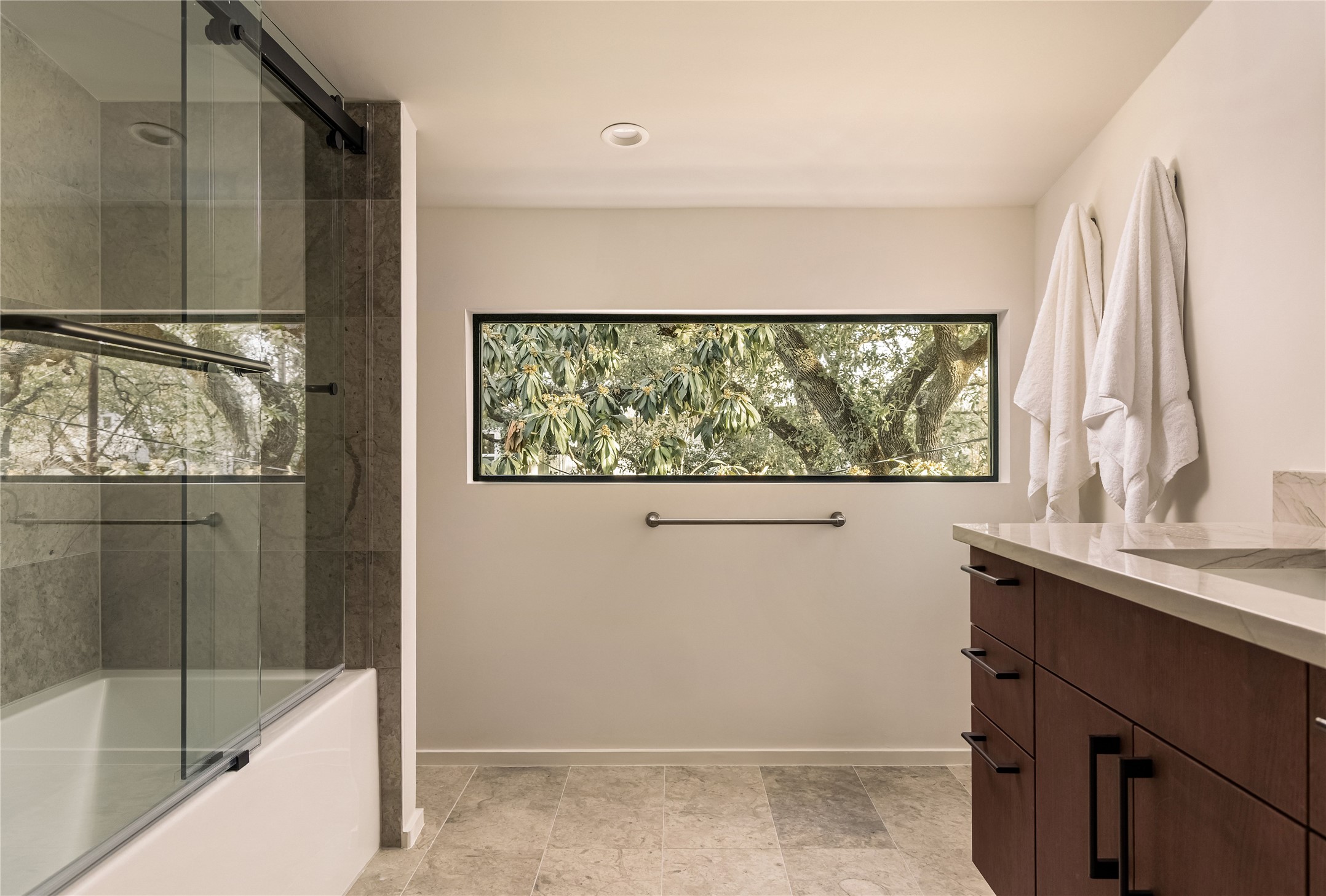 915 Columbus Street Austin, TX 78704 - Photo 27 of 34 Full bath with vanity and shower / bath combination with glass door