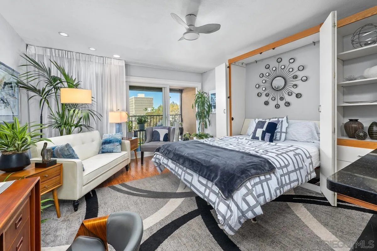 3980 8th Avenue, Unit 308 San Diego, CA 92103 - Photo 5 of 33 a spacious bedroom with a bed a couch and potted plant