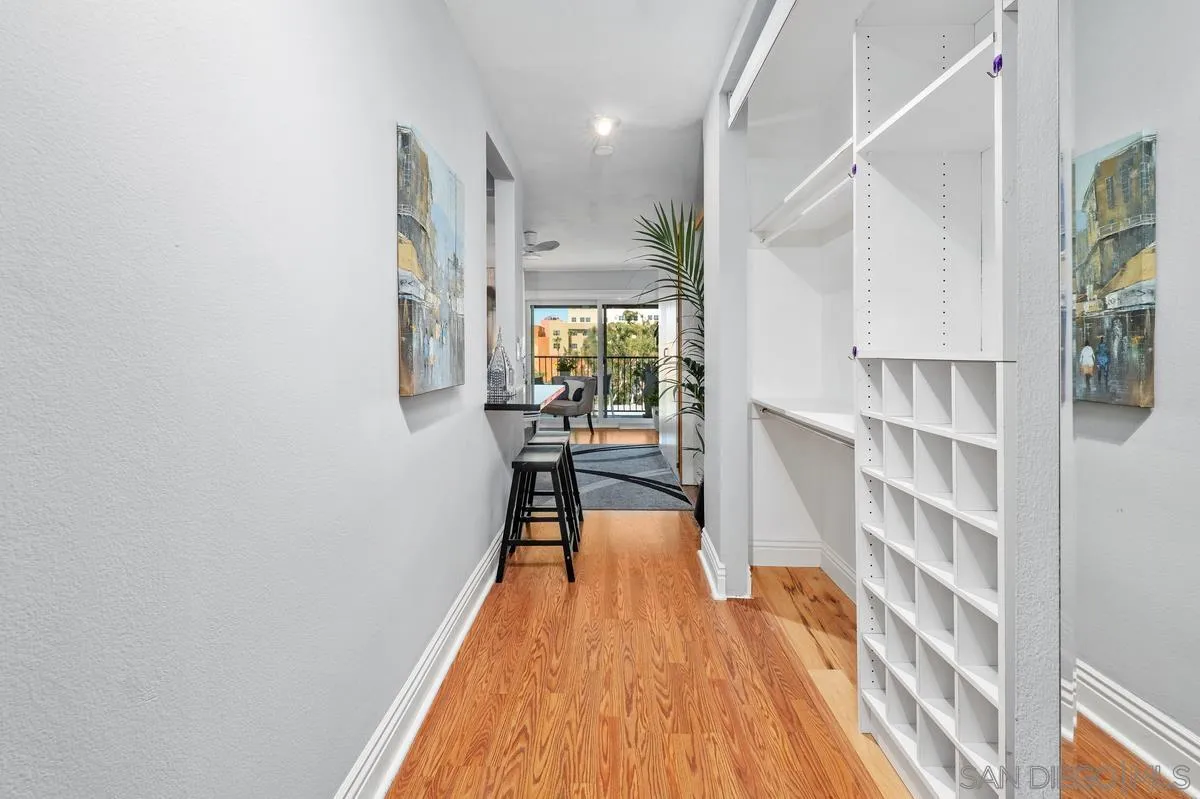 3980 8th Avenue, Unit 308 San Diego, CA 92103 - Photo 7 of 33 a view of a room with wooden floor and furniture