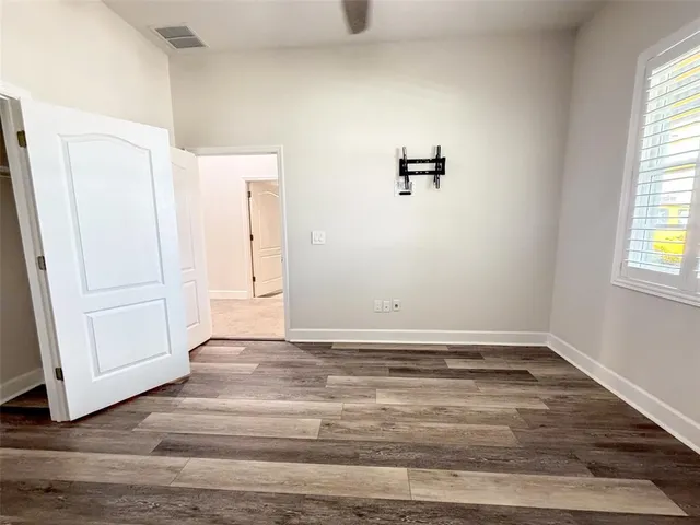 a view of a livingroom with wooden floor and window
