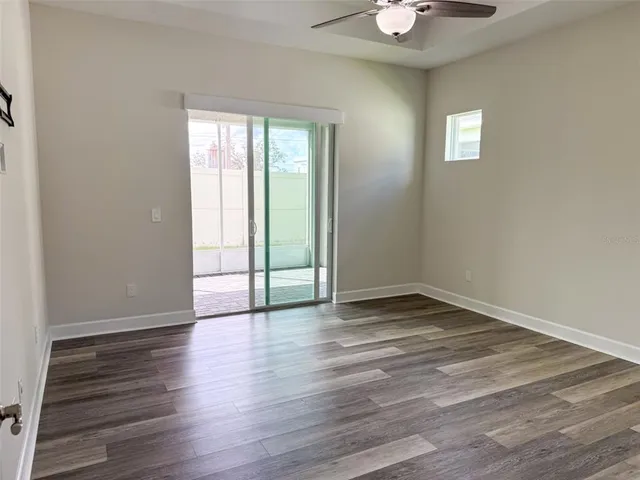 wooden floor in an empty room with a window