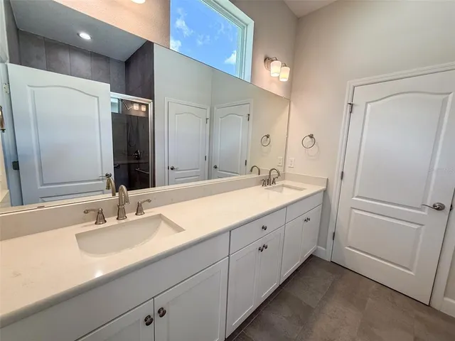 a bathroom with a double vanity sink and mirror