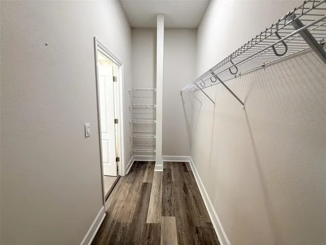 a view of a room with wooden floor and staircase