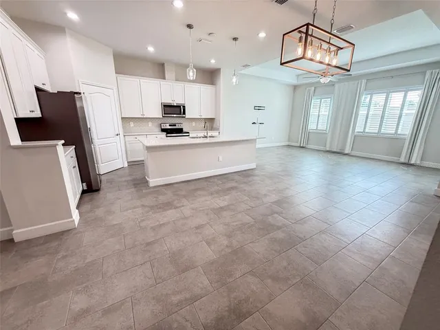 a large kitchen with cabinets and stainless steel appliances