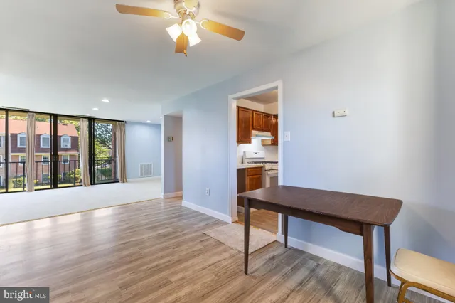 a view of a room with window wooden floor and front door