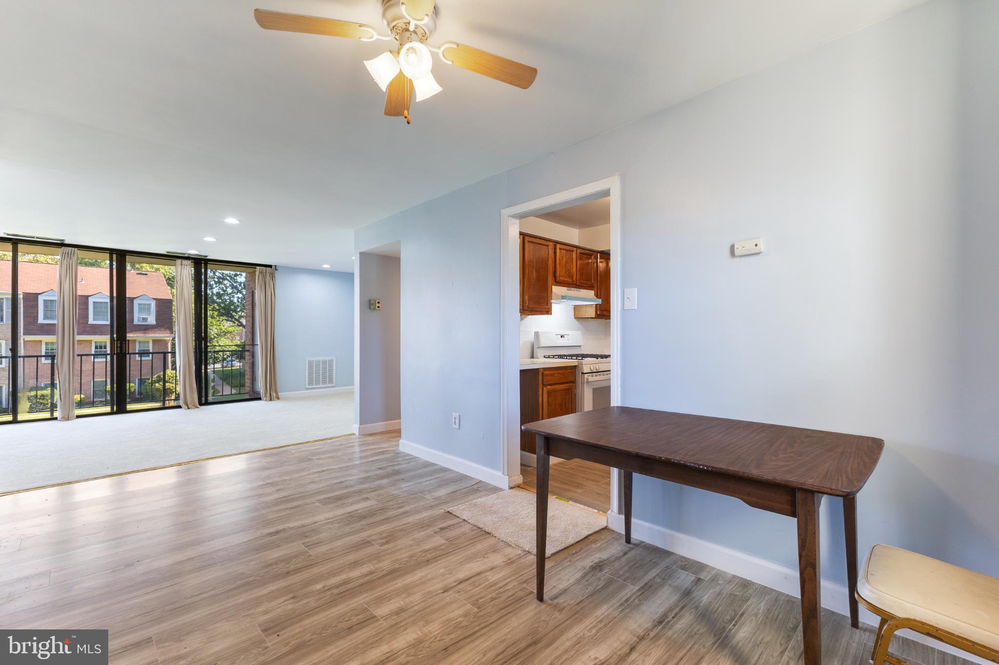 776 Quince Orchard Boulevard, Unit 102 Gaithersburg, MD 20878 - Photo 6 of 14 a view of a room with window wooden floor and front door