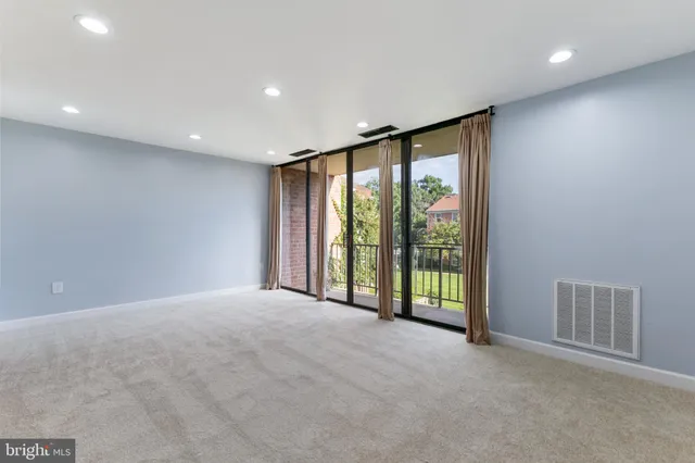 a view of an empty room with glass door