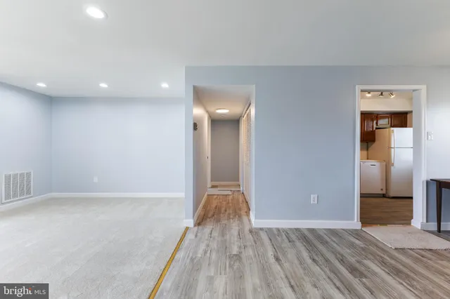 a view of hallway with stairs and a wooden floor