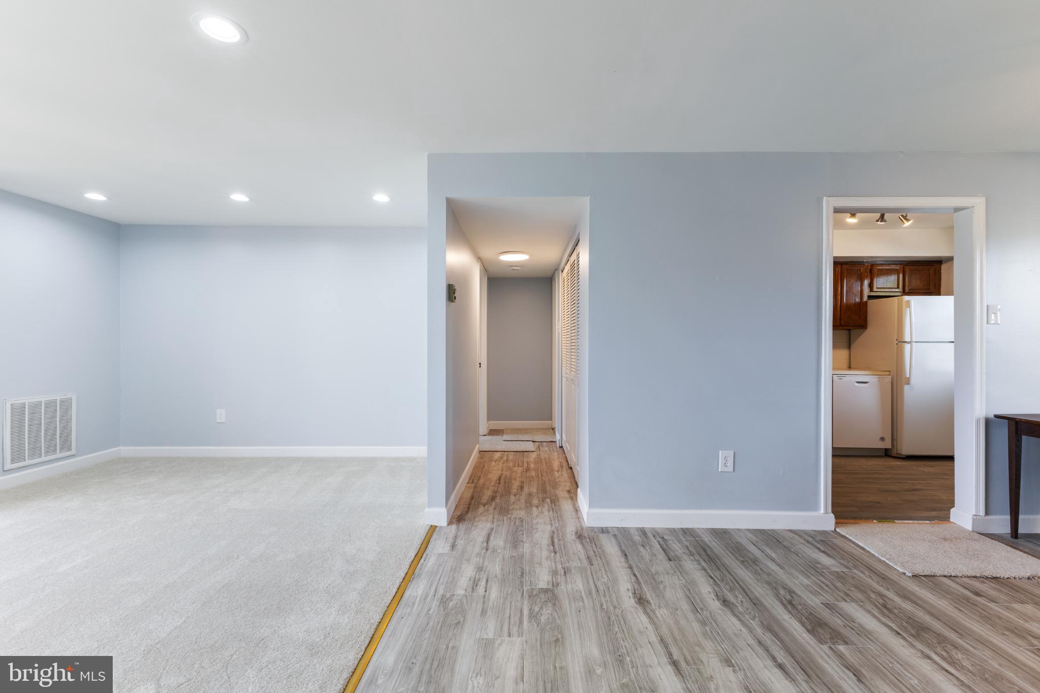 776 Quince Orchard Boulevard, Unit 102 Gaithersburg, MD 20878 - Photo 8 of 14 a view of hallway with stairs and a wooden floor