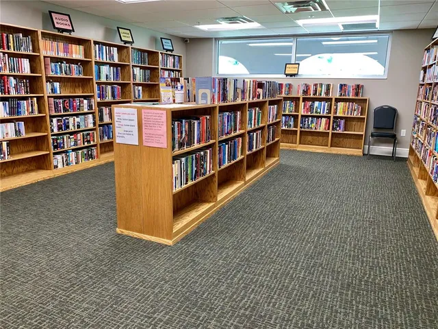 a living room with lots of books