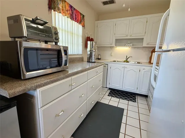 a kitchen with stainless steel appliances cabinets a microwave oven and a sink