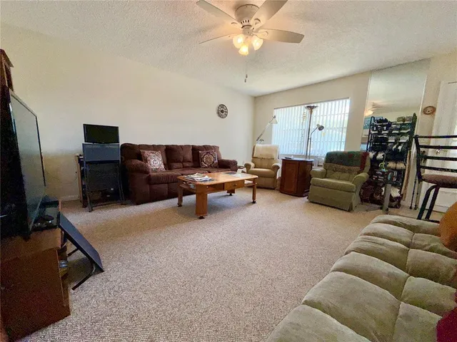 a livingroom with workspace couch and a window