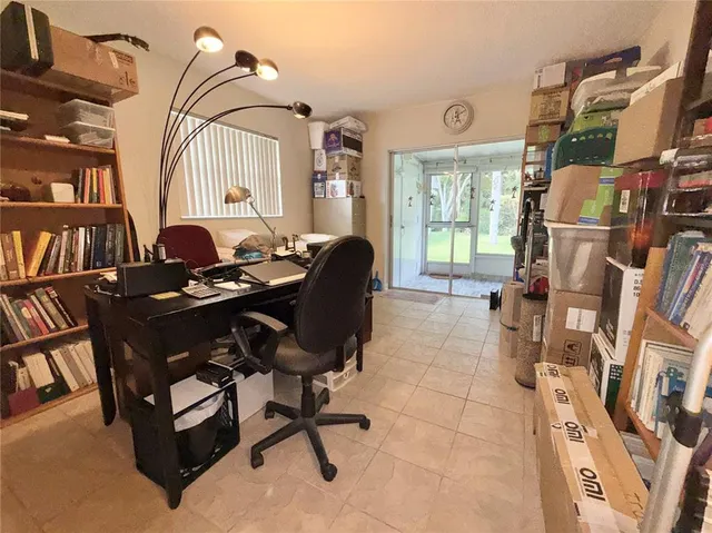 a living room with furniture cabinets and a window