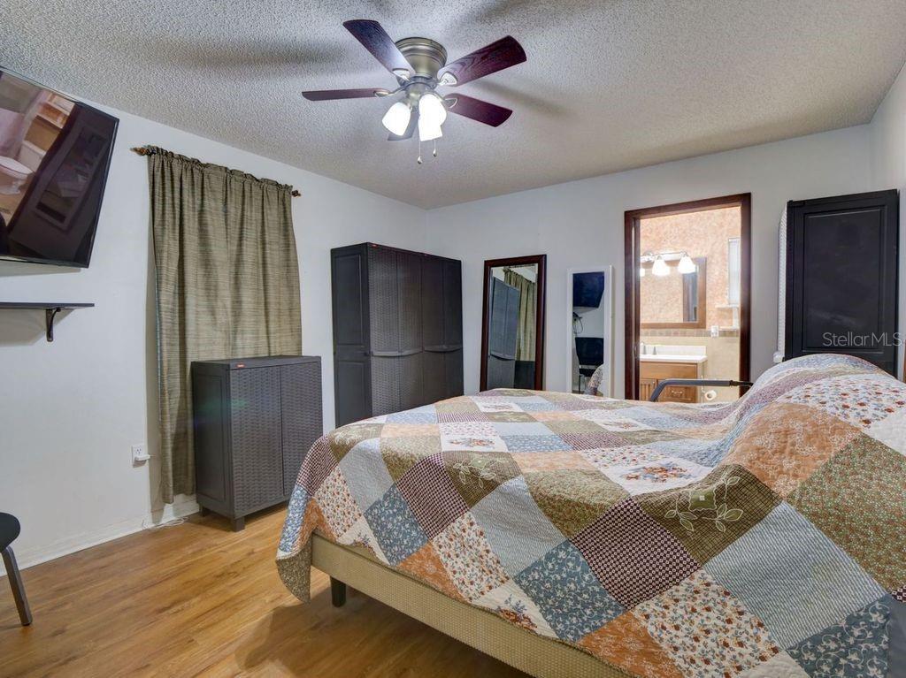 698 Colchester Avenue Deltona, FL 32738 - Photo 12 of 30 a bedroom with a bed and a chandelier