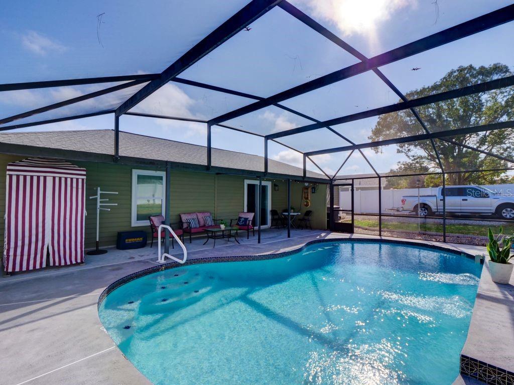 698 Colchester Avenue Deltona, FL 32738 - Photo 18 of 30 a view of a swimming pool with a patio