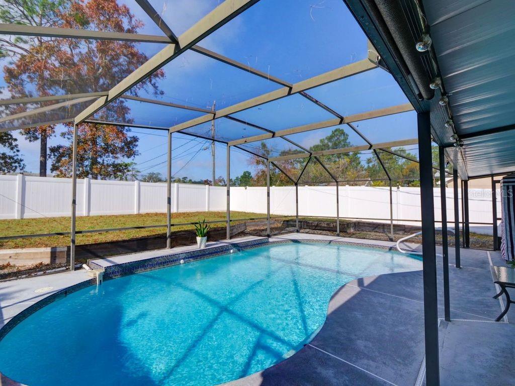 698 Colchester Avenue Deltona, FL 32738 - Photo 20 of 30 a view of a backyard with a swimming pool
