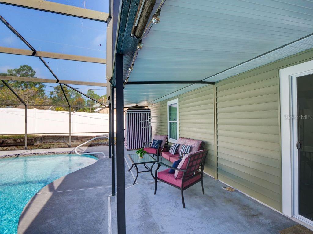 698 Colchester Avenue Deltona, FL 32738 - Photo 21 of 30 a view of a porch with furniture and a yard