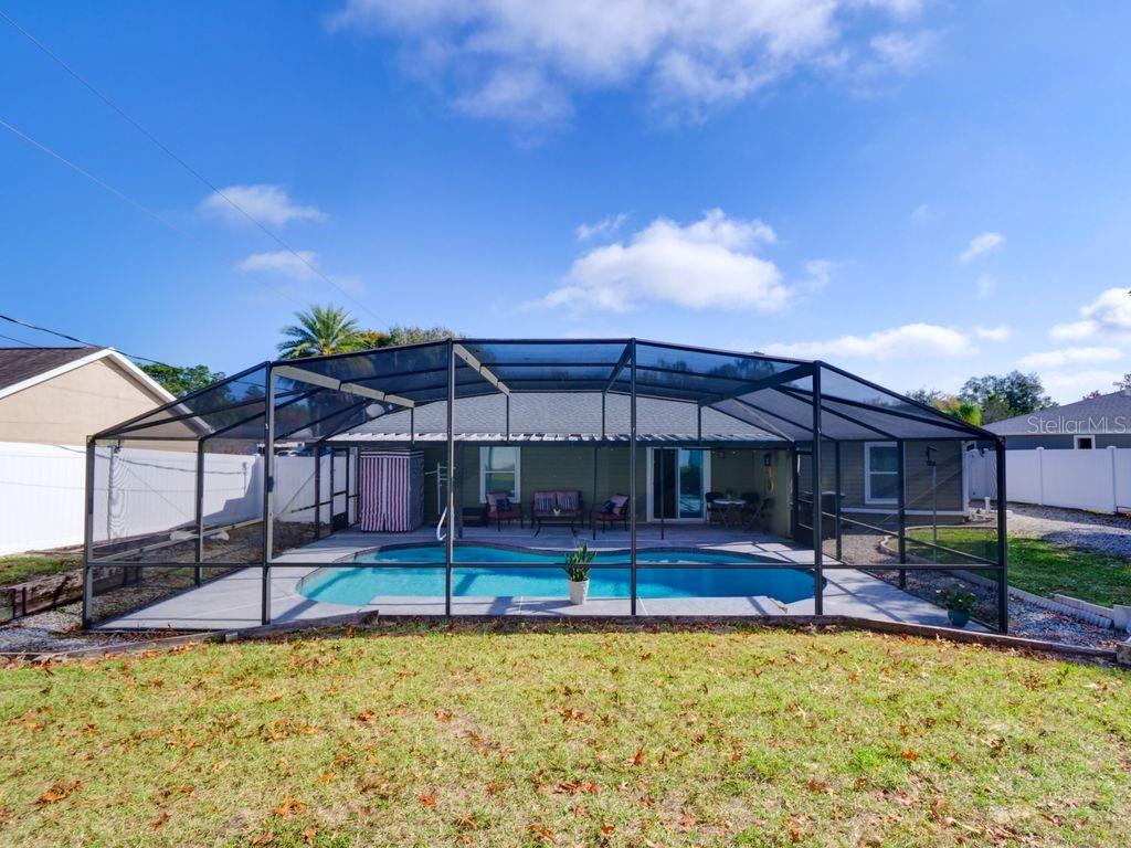 698 Colchester Avenue Deltona, FL 32738 - Photo 22 of 30 a view of a house with swimming pool and porch