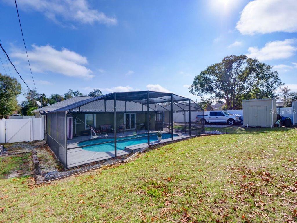 698 Colchester Avenue Deltona, FL 32738 - Photo 23 of 30 a view of a backyard with a small cabin