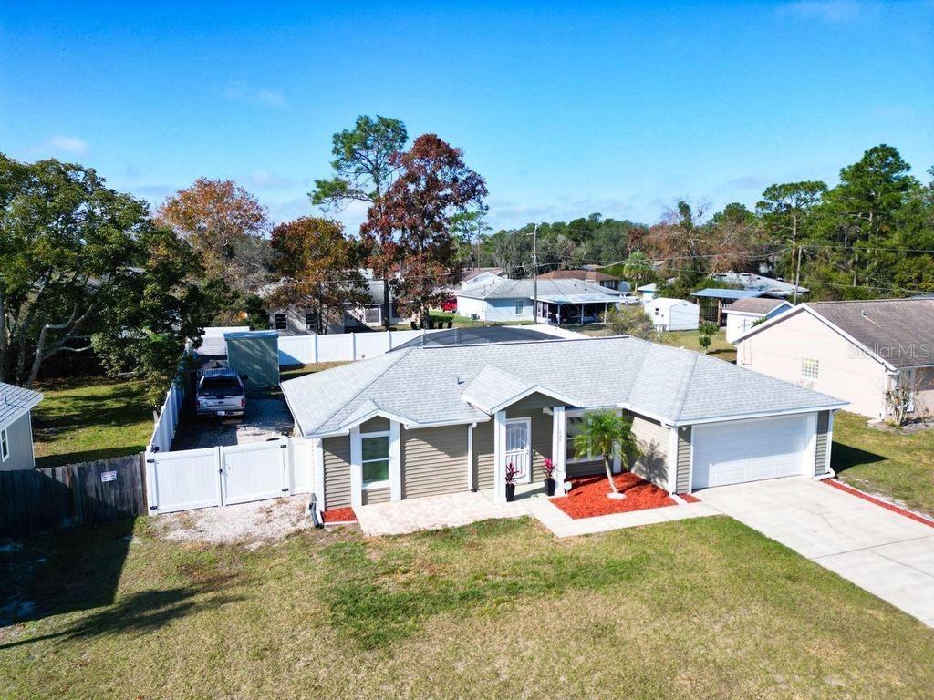 698 Colchester Avenue Deltona, FL 32738 - Photo 28 of 30 a view of a house with swimming pool and a yard