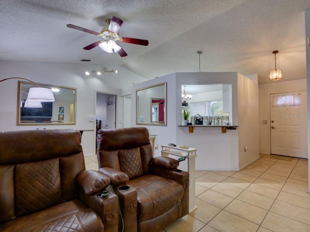 698 Colchester Avenue Deltona, FL 32738 - Photo 3 of 30 a living room with furniture and a chandelier