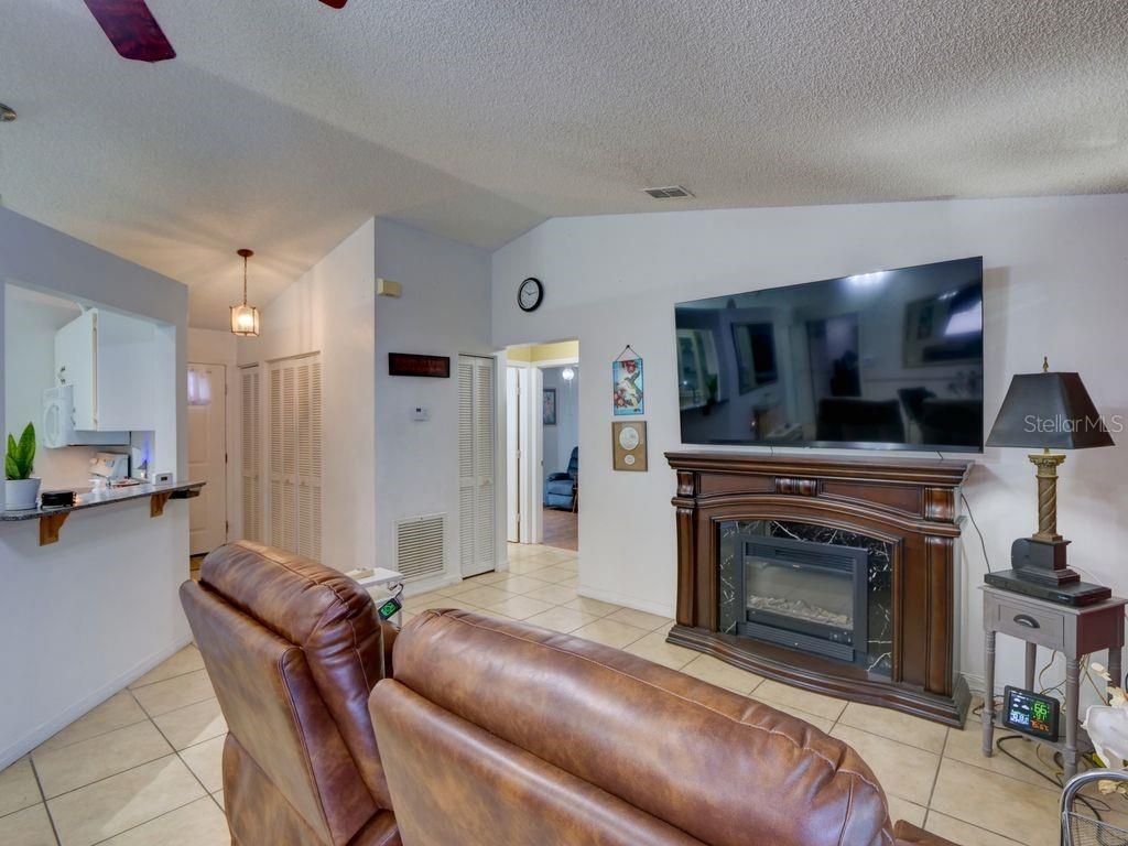 698 Colchester Avenue Deltona, FL 32738 - Photo 4 of 30 a living room with furniture and a fireplace