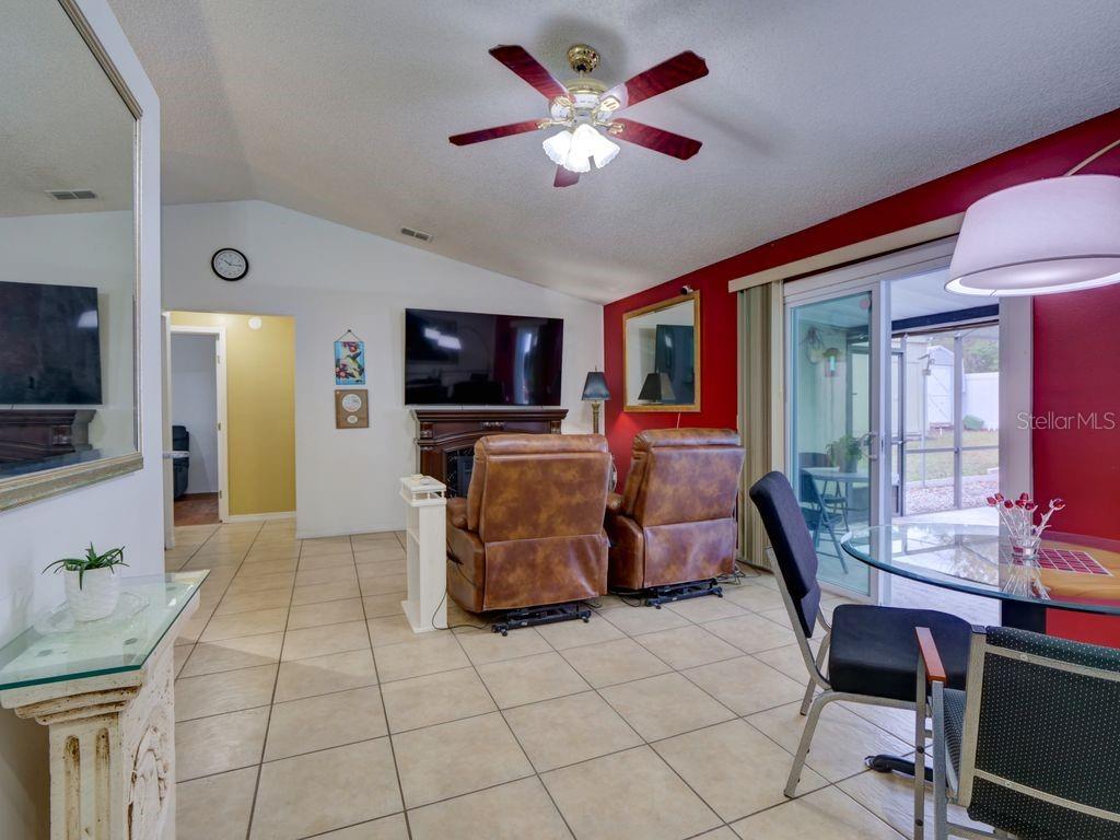 698 Colchester Avenue Deltona, FL 32738 - Photo 7 of 30 a living room with furniture and a flat screen tv