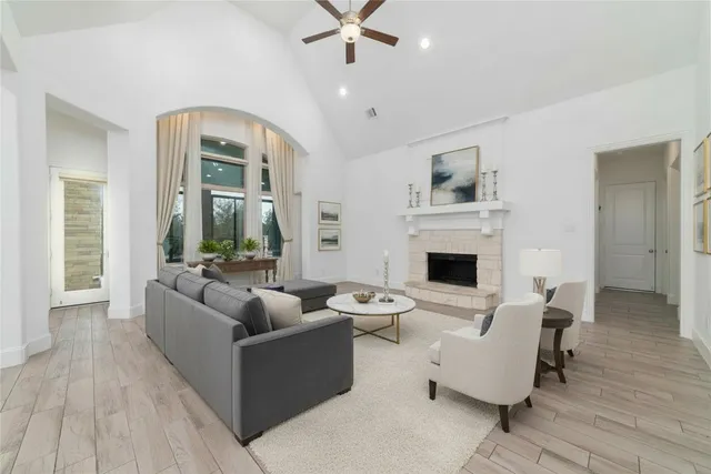 a living room with furniture a fireplace and a flat screen tv