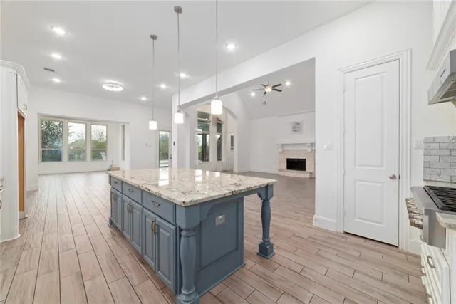 a kitchen with stainless steel appliances granite countertop a stove and refrigerator