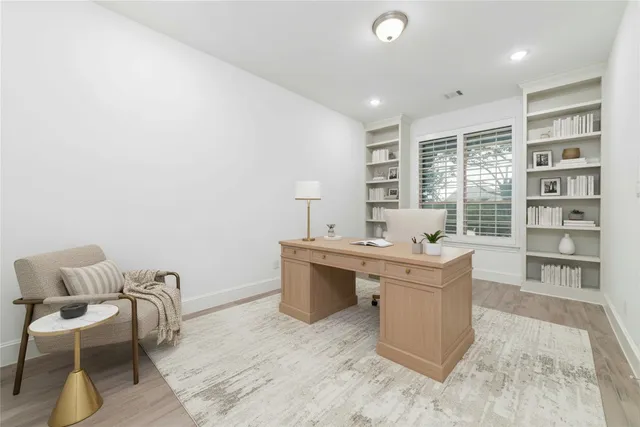 a kitchen with a sink and chairs