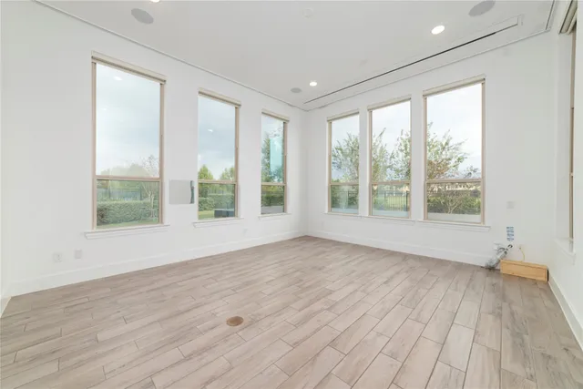 a view of room with window and wooden floor