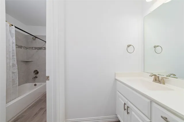 a bathroom with a sink a mirror and a bathtub