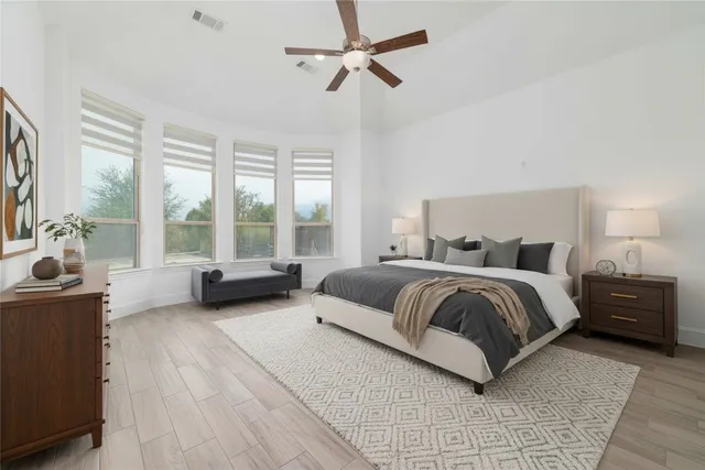 a spacious bedroom with a bed and a couch