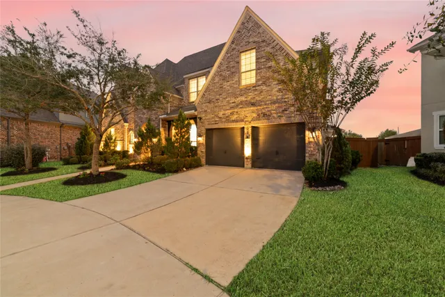 a front view of house with yard and green space