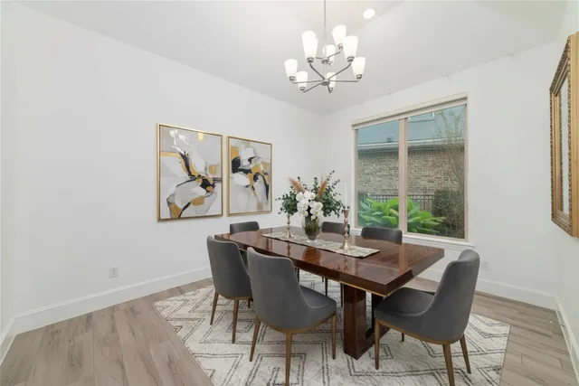 a view of a dining room with furniture wooden floor and a chandelier