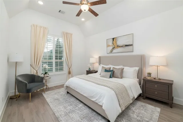 a bedroom with a bed and a chair