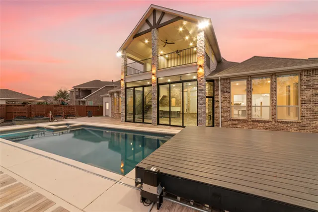 a view of a house with swimming pool and sitting area