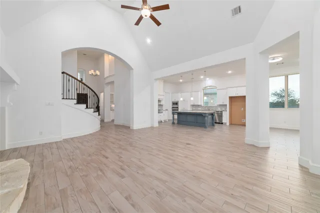 a view of a living room and a kitchen with furniture wooden floor