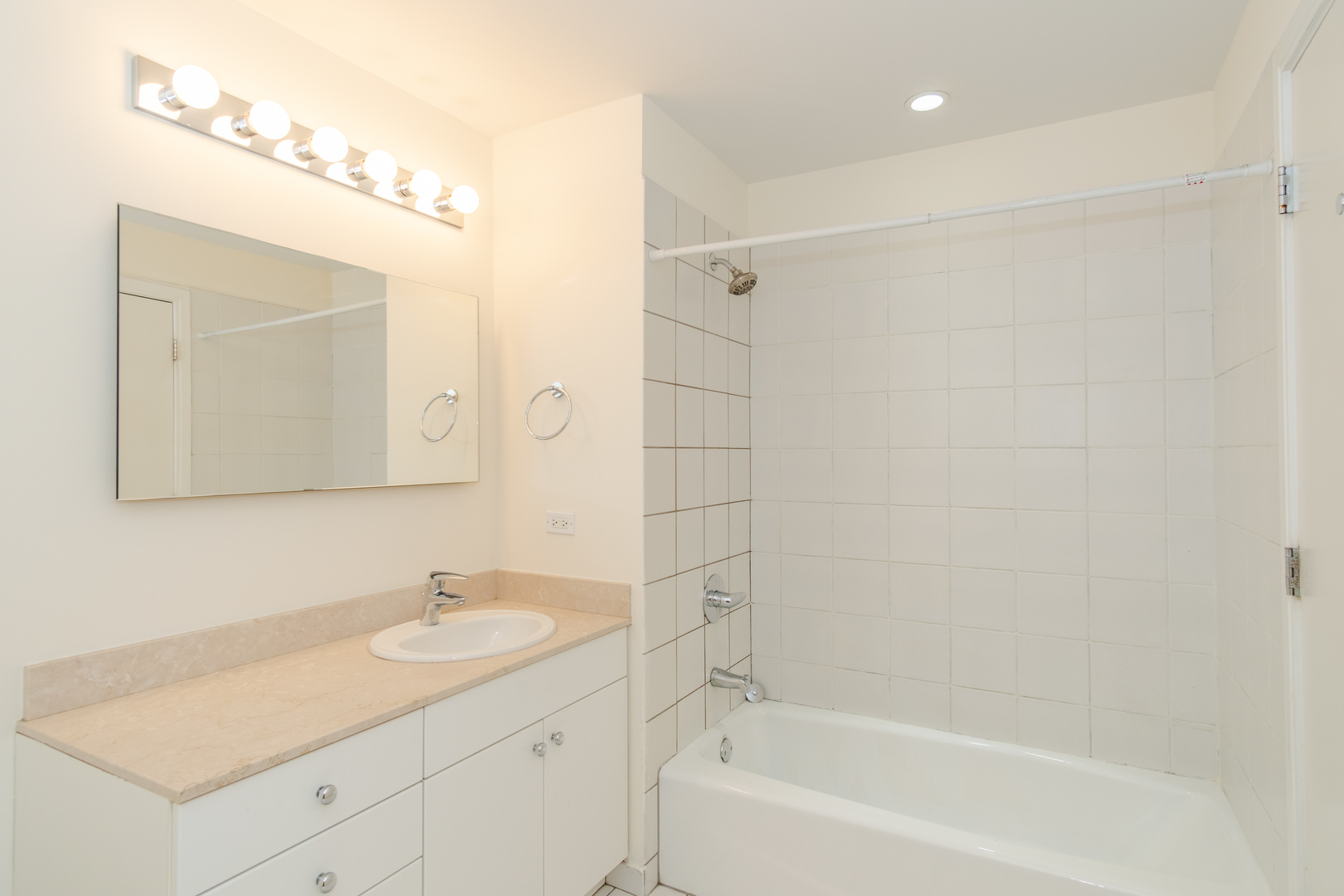 8 East Randolph Street, Unit 1806 Chicago, IL 60601 - Photo 20 of 23 a bathroom with a granite countertop sink a mirror and a bathtub