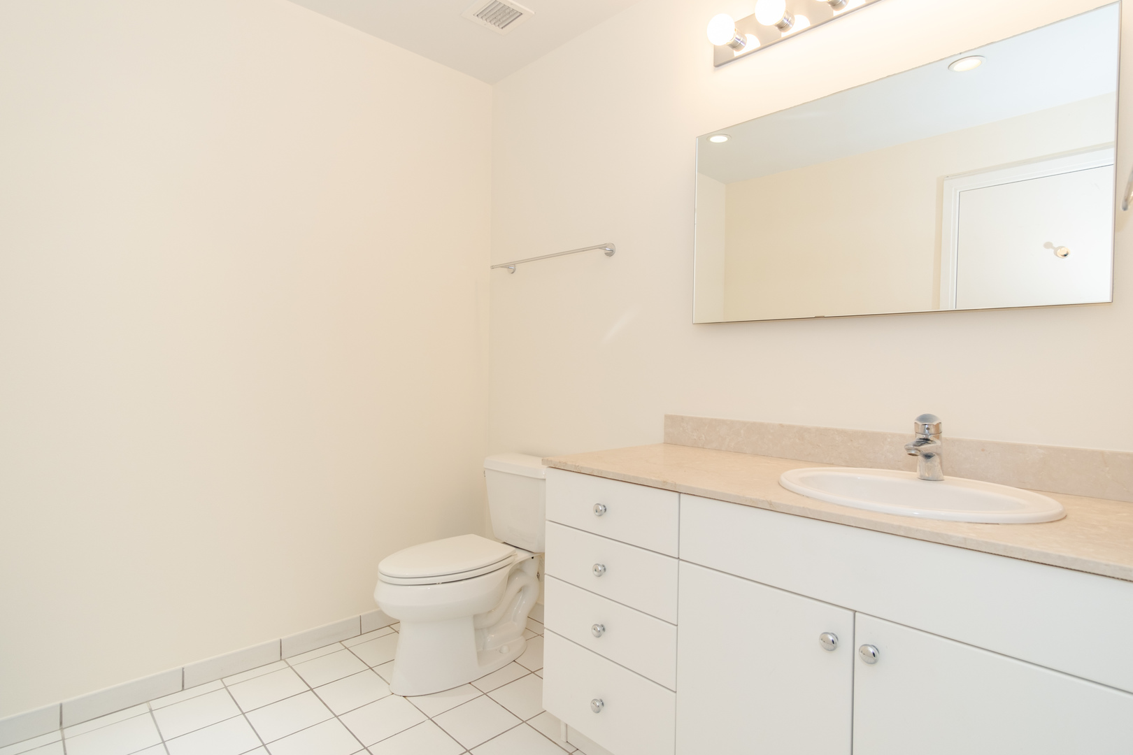 8 East Randolph Street, Unit 1806 Chicago, IL 60601 - Photo 21 of 23 a bathroom with a granite countertop sink a toilet and a mirror