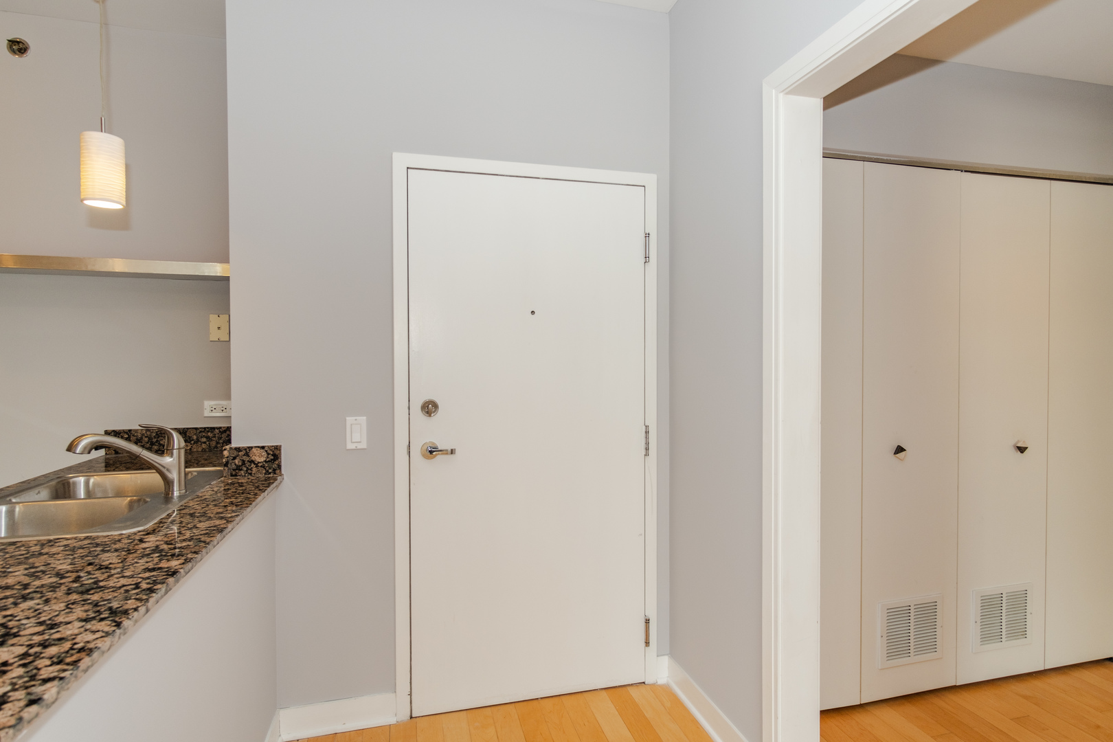 8 East Randolph Street, Unit 1806 Chicago, IL 60601 - Photo 6 of 23 a bathroom with a granite countertop sink and washing machine