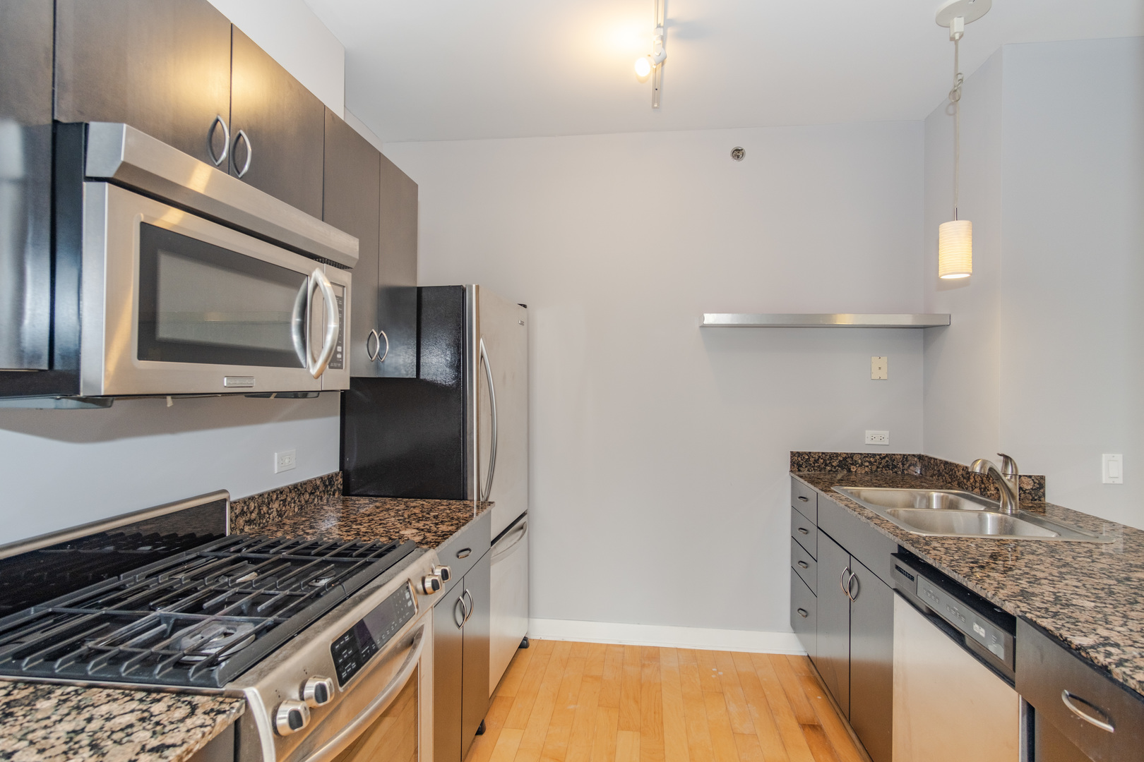 8 East Randolph Street, Unit 1806 Chicago, IL 60601 - Photo 10 of 23 a kitchen with stainless steel appliances granite countertop a stove and a microwave