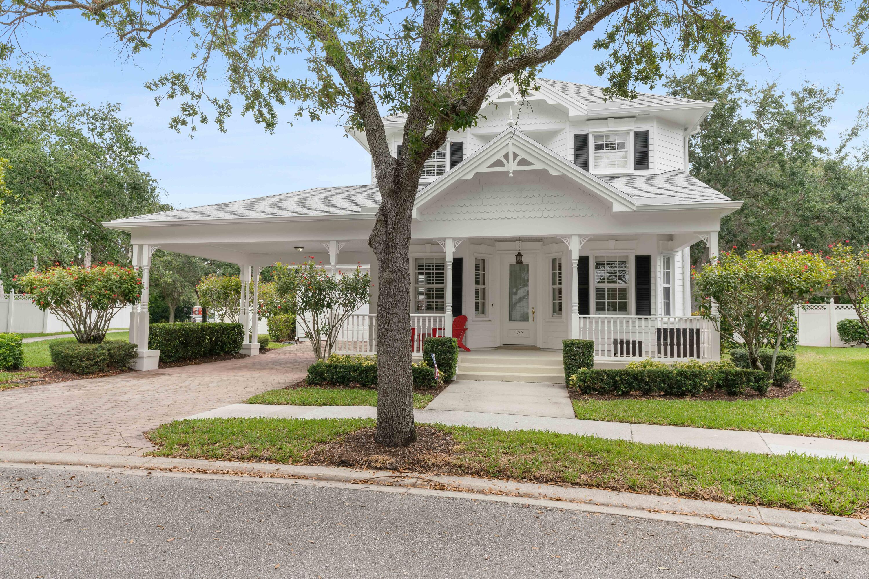 144 Sweet Bay Circle Jupiter, FL 33458 - Photo 16 of 46 a front view of a house with a yard and potted plants