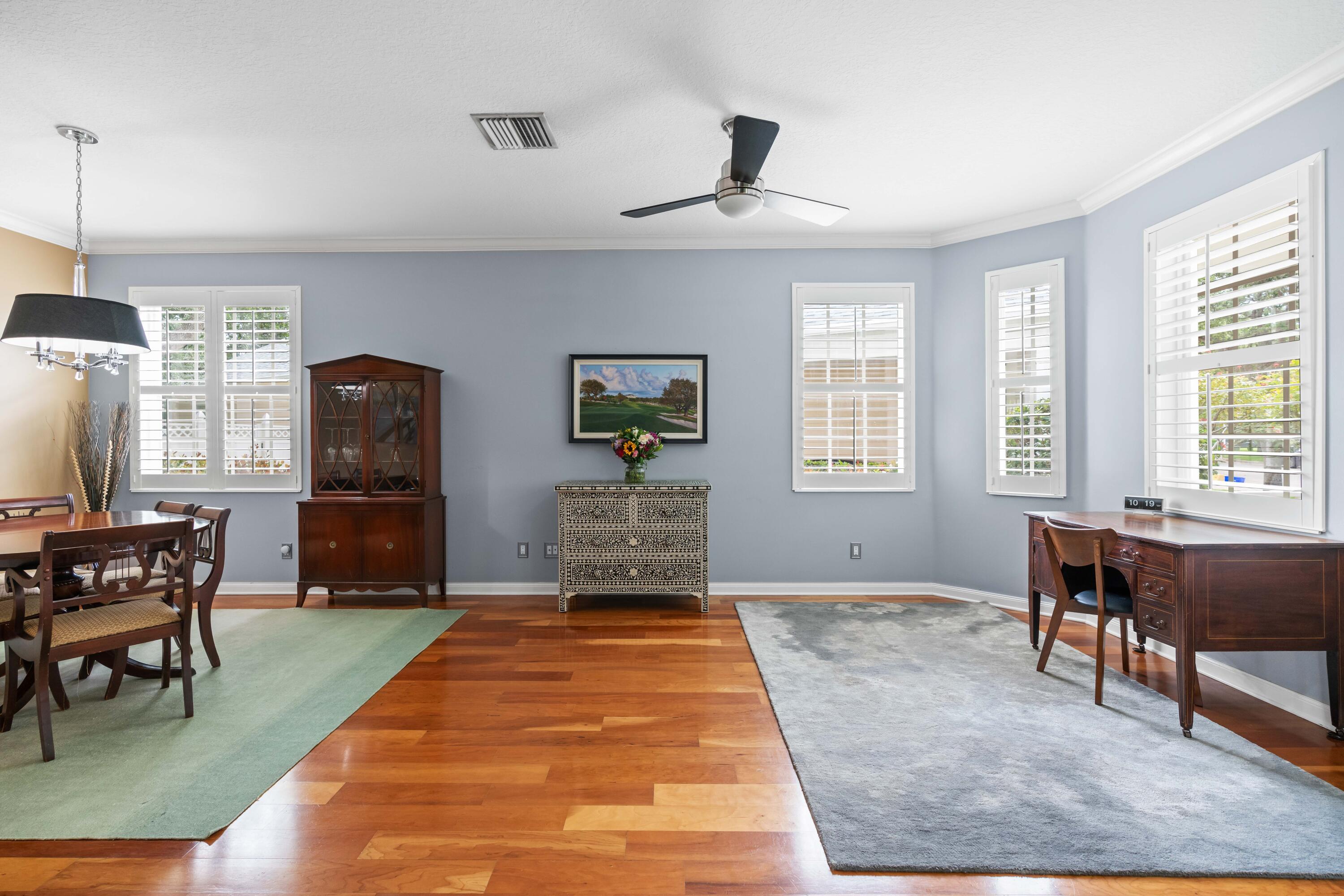 144 Sweet Bay Circle Jupiter, FL 33458 - Photo 18 of 46 a spacious bedroom with a bed and a table in it