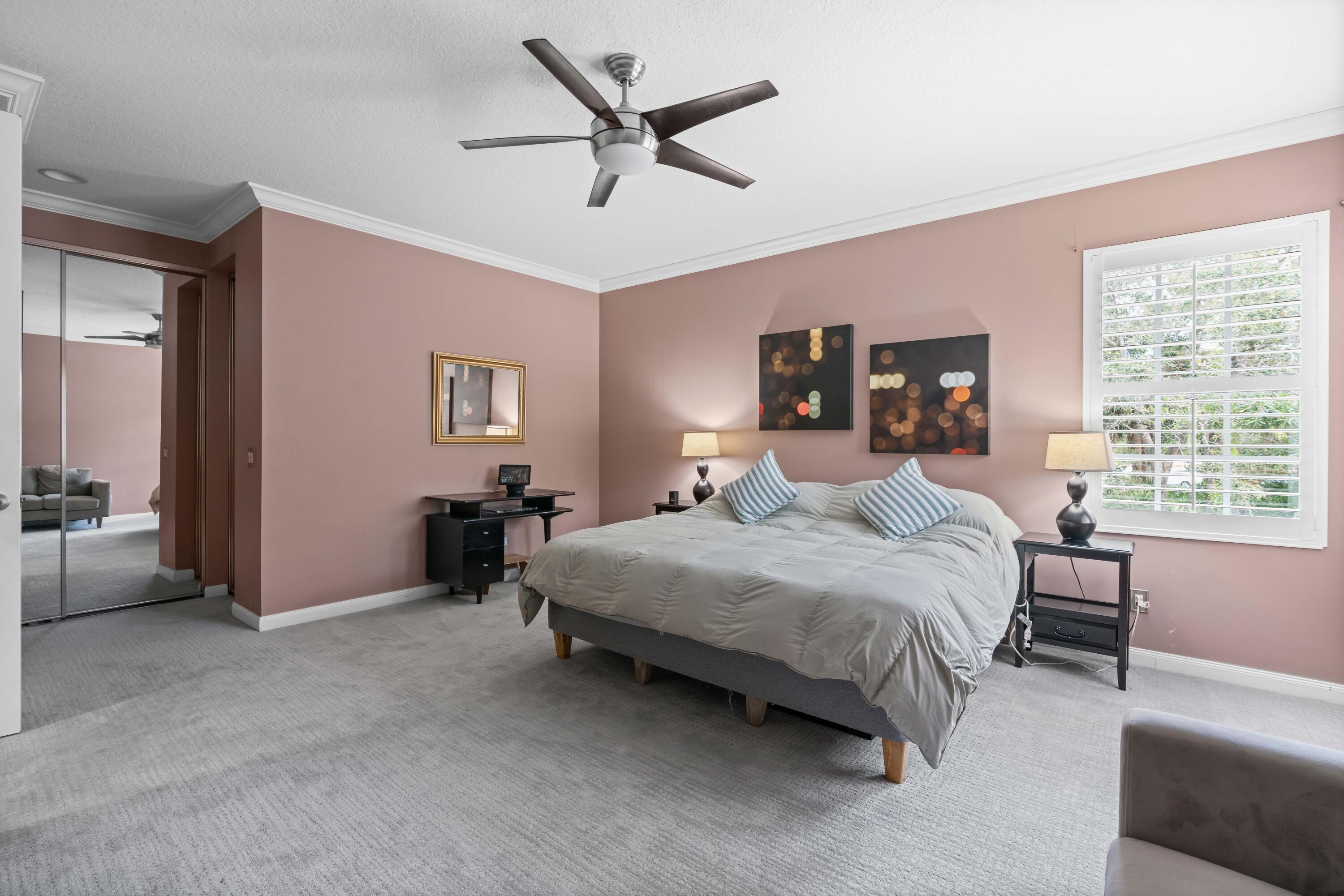 144 Sweet Bay Circle Jupiter, FL 33458 - Photo 29 of 46 a bedroom with a bed a couch and a large window