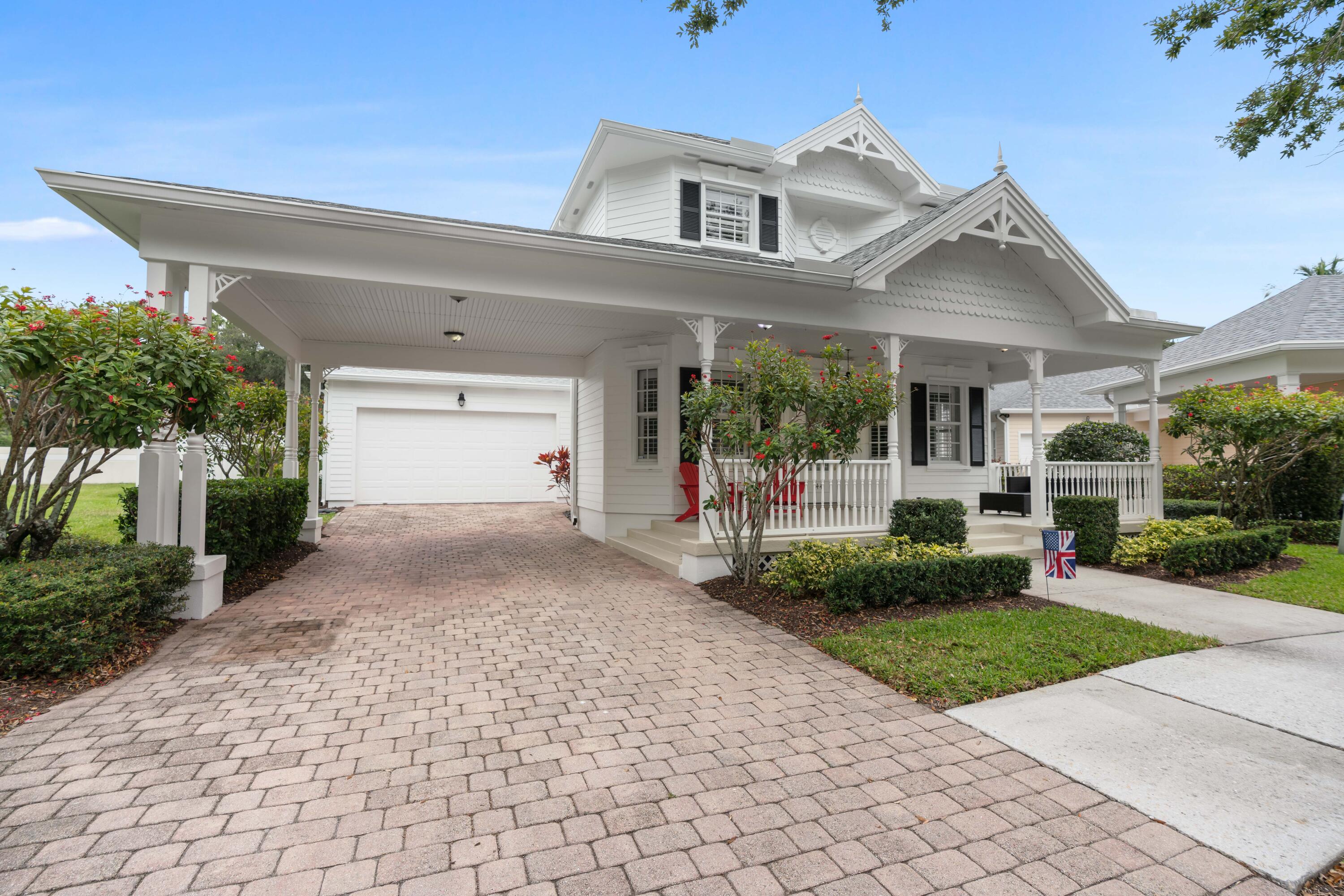 144 Sweet Bay Circle Jupiter, FL 33458 - Photo 35 of 46 a view of a white house with a small yard and large tree